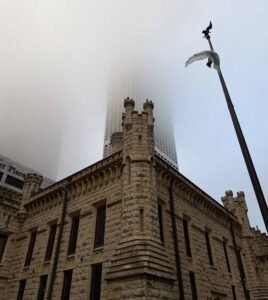 Chicago Water Tower on a foggy morning with skyscraper disappearing into clouds, Michigan Avenue Chicago