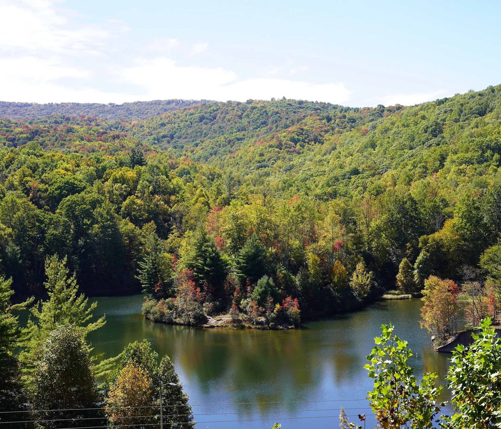 Early fall color on a wooded peninsula in a mountain lake, Beech Mountain, North Carolina